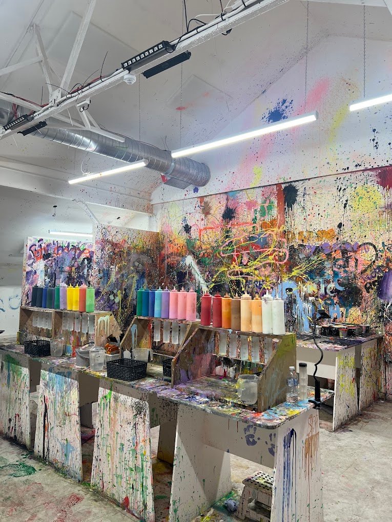 Guests mixing colours and creating fluid art during a unique paint experience at one of the best indoor activities in Liverpool