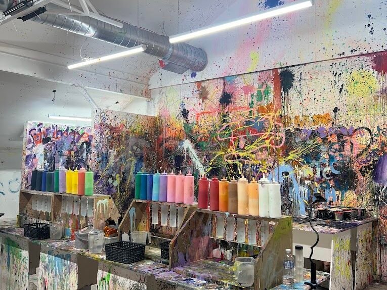 Guests mixing colours and creating fluid art during a unique paint experience at one of the best indoor activities in Liverpool